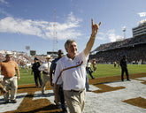 Mack Brown Making Hook'em Sign